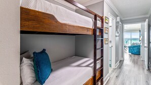 Un lit superposé dans une chambre avec vue sur le balcon.
