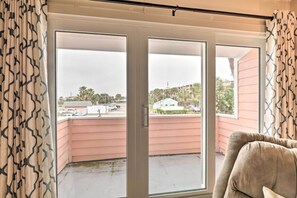 Enjoy the view from the balcony with a sofa positioned to take it all in.