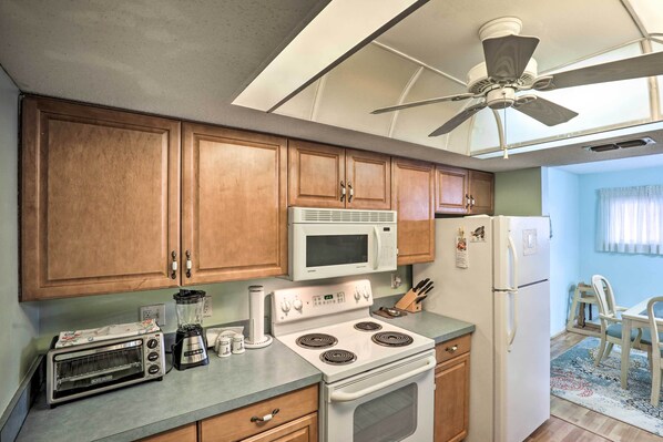 Enjoy cooking in this well-equipped kitchen with a stovetop, microwave, and refrigerator.