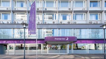 A hotel with a purple facade, multiple floors, and a prominent 'Premier Inn' sign.