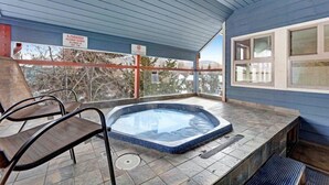 A covered outdoor hot tub area with a view of trees and mountains. - 2 Bedroom Ski in Condo Only One Block From Historic Downtown, Shopping, Restaurants and Entertainment (Breckenridge)