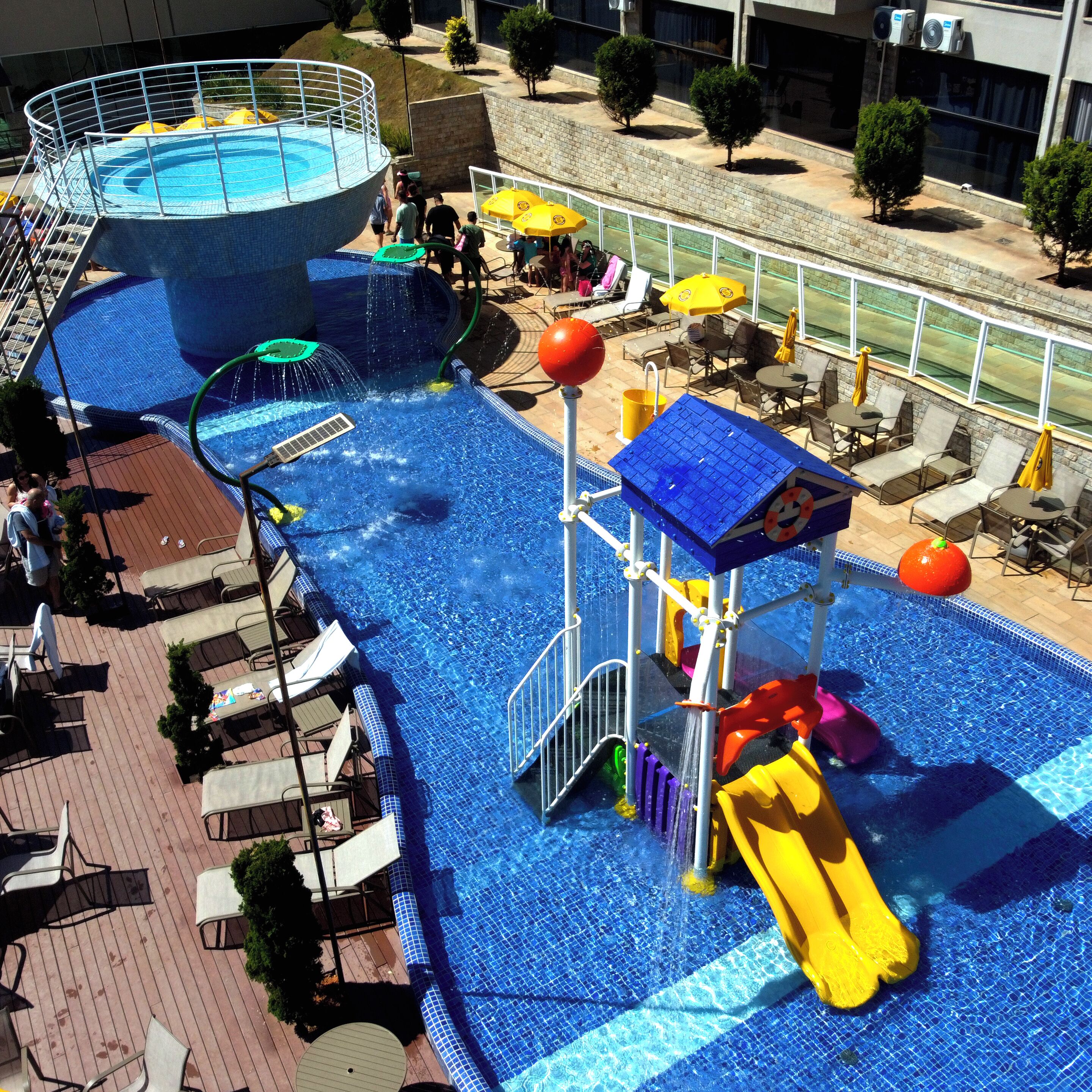 A water park with slides, a pool, and lounge areas.
