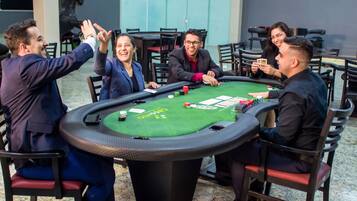 Players gather around the blackjack table, surrounded by standard casino chips and playing cards.
