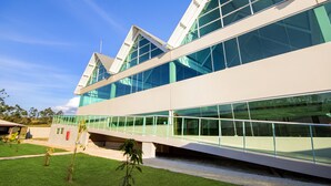 A modern building with large glass windows and a flat roof.