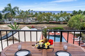 Enjoy a casual meal on the balcony overlooking the pool and ocean views.