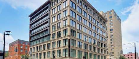 A multi-story hotel with a corner location, large windows, and a modern architectural design.