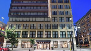 A multi-story hotel with a classic facade, large windows, and a prominent entrance with a marquee sign. - TownePlace Suites by Marriott Cincinnati Downtown (Cincinnati)