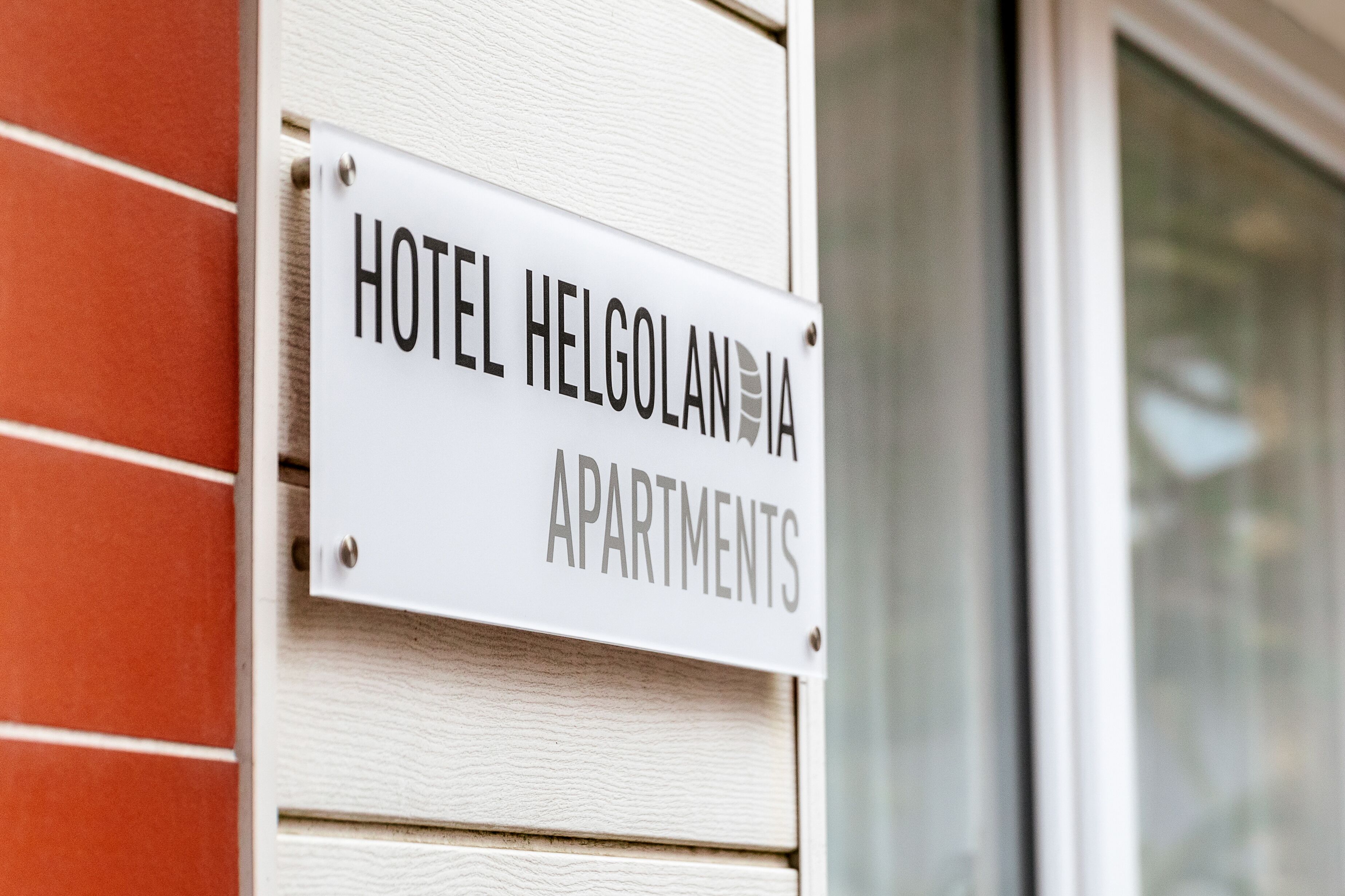 A sign for Hotel Helgolandia Apartments.