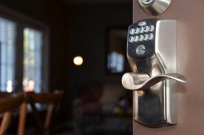 A modern door lock with a keypad and a keyhole, indicating a secure entry point.