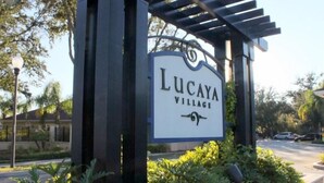 A sign for Lucaya Village with a pergola structure. - Lucaya 4 Bedrooms 3 Baths Townhome With Central Kitchen (Kissimmee)