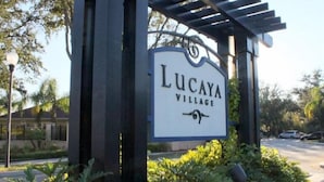A sign for Lucaya Village with a pergola structure. - Modern Lucaya 4 Bedrooms 3 Baths Townhome (Kissimmee)