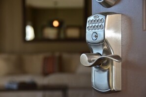 A modern door lock with a keypad and a keyhole. - Lucaya 4 Bedrooms 3 Baths Family Friendly Townhome (Kissimmee)