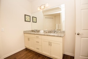 A bathroom with a double sink vanity, a large mirror, and two framed pictures on the wall. - December Special LV 3 Beds 2 Baths Id:61208 (Kissimmee)