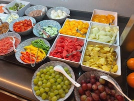 A buffet with various fruits and vegetables.