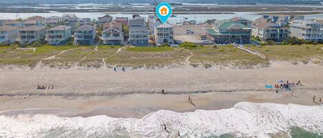 Zona residencial costera con propiedades frente al mar, incluyendo casas y un hotel con vista a la playa.