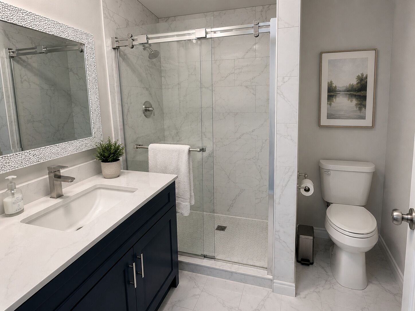 A bathroom with a shower, toilet, sink, and a framed picture on the wall.