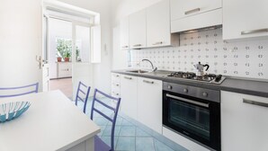 A modern kitchen with white cabinets, a gas stove, and a built-in oven. - Marina Piccola is located in the center of the island, a stone's throw from the beach  (Procida)