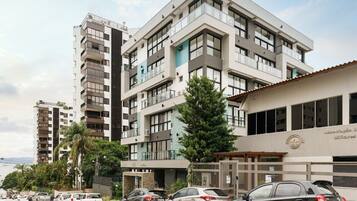 A multi-story building with a modern design, featuring balconies and large windows.