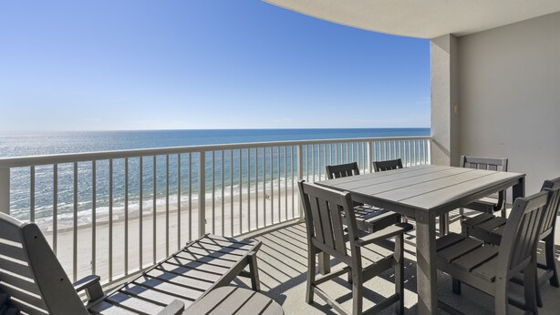 A balcony with a view of the beach and ocean, a table, and chairs. - Island Royale 903 by Liquid Life (Gulf Shores)