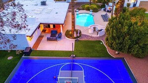 An outdoor basketball court with a pool and seating area. - Luxury Desert Oasis+Sport Court+Theater+Golf+ Spa (Scottsdale)