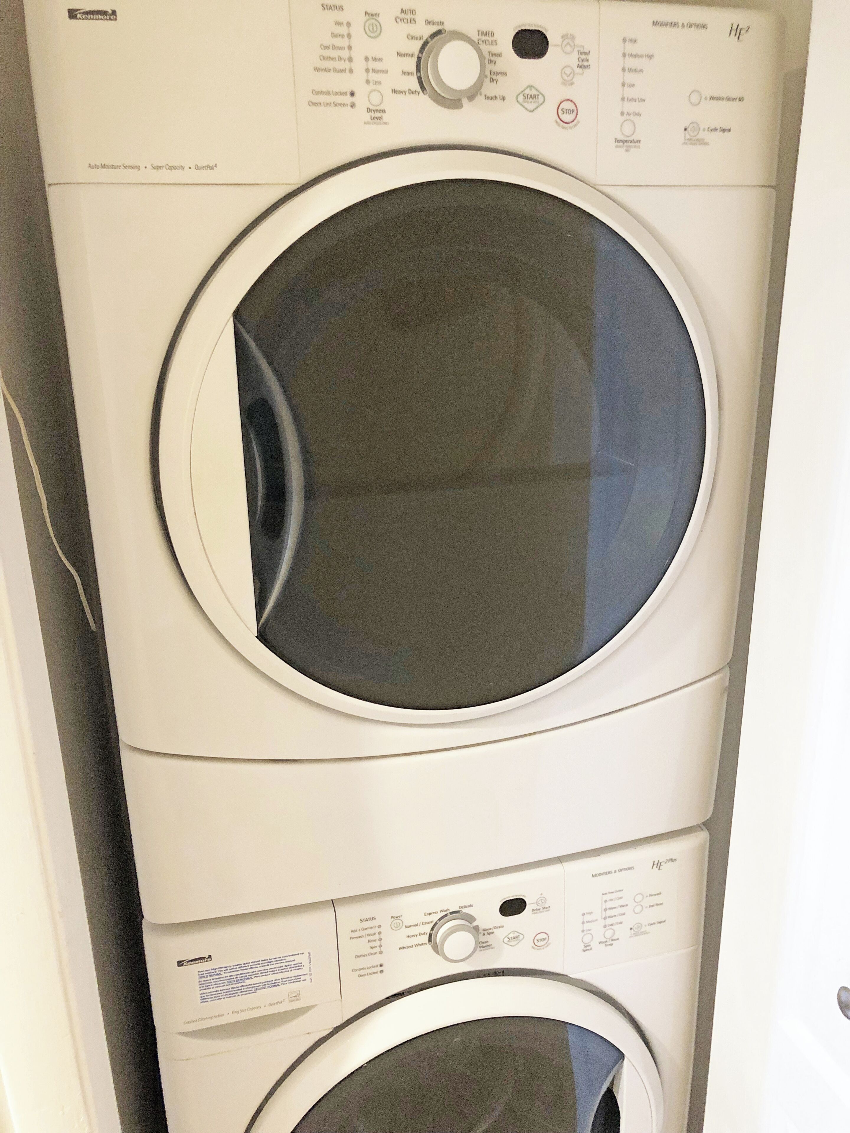 A front view of a Kenmore HE27P front-loading washer and dryer unit.