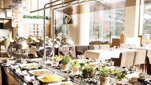 A buffet setup with various food items and a glass display case. - Sono Pet Clubs & Resorts VivaldiPark (Hongcheon)