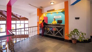 A reception desk with a sign reading "RECEPTION" and "GOSTOPS". - goSTOPS Mussoorie, Picture Palace (Dehradun)