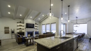 A modern kitchen with a large island, built-in appliances, and pendant lighting. - Arcadia 54 | Private Hot Tub * Ping Pong * Nintendo (Santa Clara)