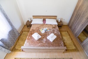 A neatly made bed with a wooden headboard, two bedside tables with lamps, and a book on the bed. - Secluded Pool Villa Sofija Near Zadar (Škabrnja)