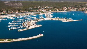 An aerial view of a marina with numerous boats docked, surrounded by a coastal town. - Secluded Pool Villa Sofija Near Zadar (Škabrnja)