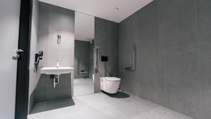 A modern bathroom with a sink, toilet, and shower. - Polonezas (Vilnius)