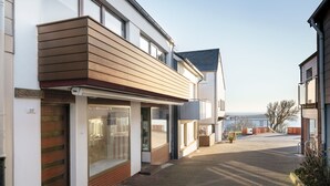 A modern building with a flat roof, large windows, and a brick facade. - Haus Germania (Helgoland)