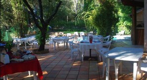 Enjoy casual outdoor dining amidst lush greenery and scenic views.