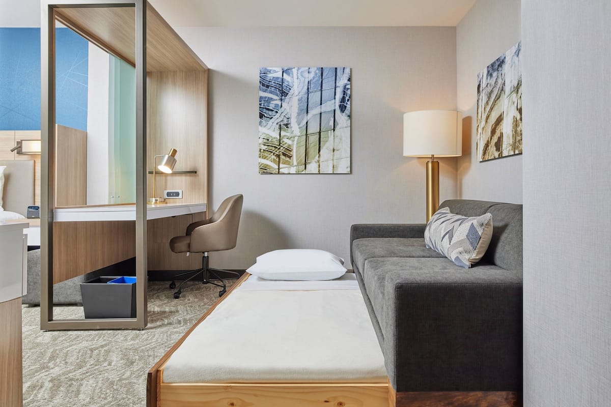 Desk, laptop workspace, iron/ironing board, bed sheets