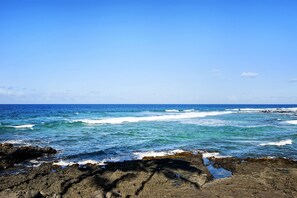 Escape to a serene coastal haven with ocean waves gently crashing onto rocky shores.