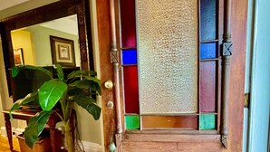 A wooden door with stained glass panels and a textured glass panel. - The Gregory House, A Southern Tropical Get Away! (Pensacola)