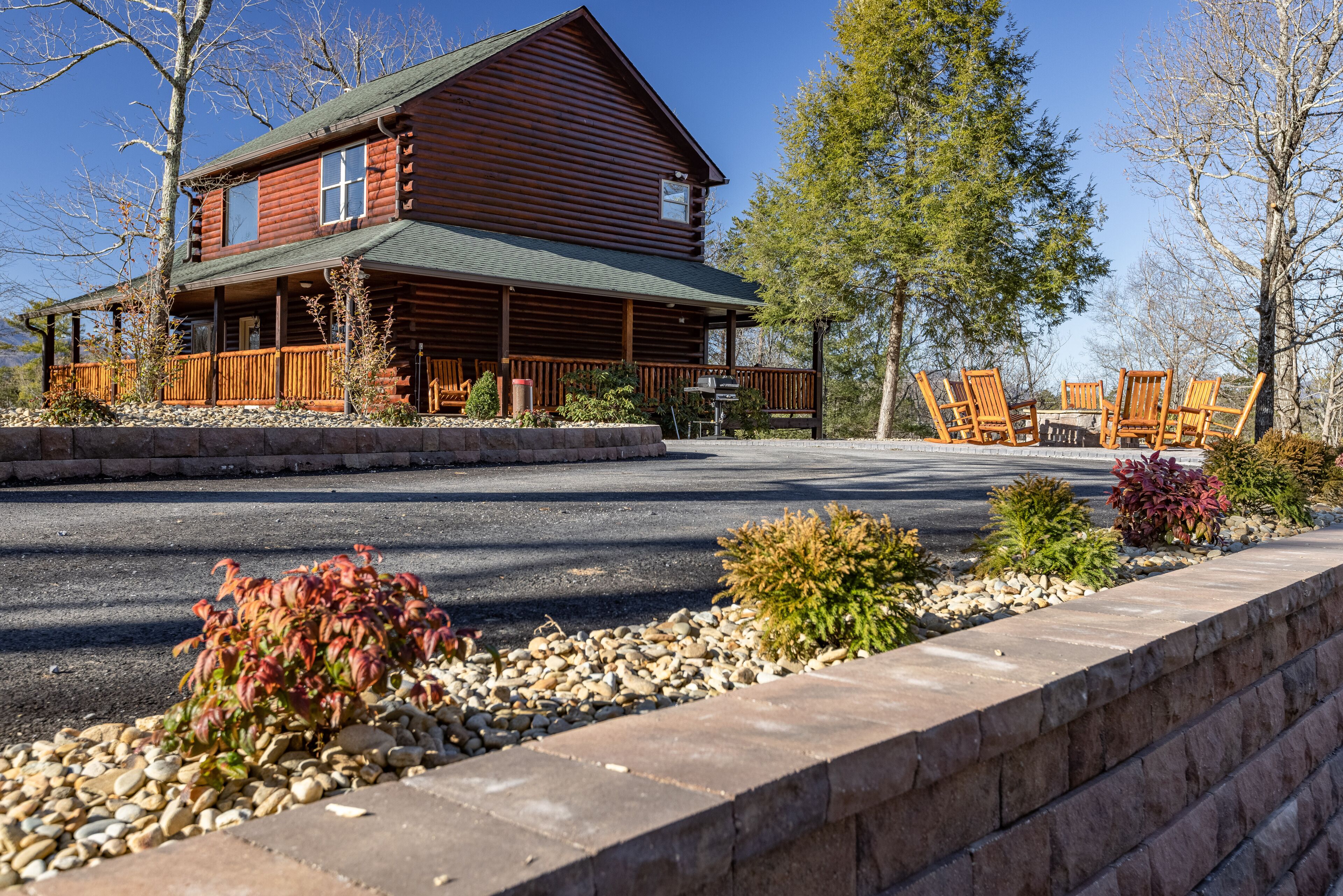 A log cabin with a porch and outdoor seating area.