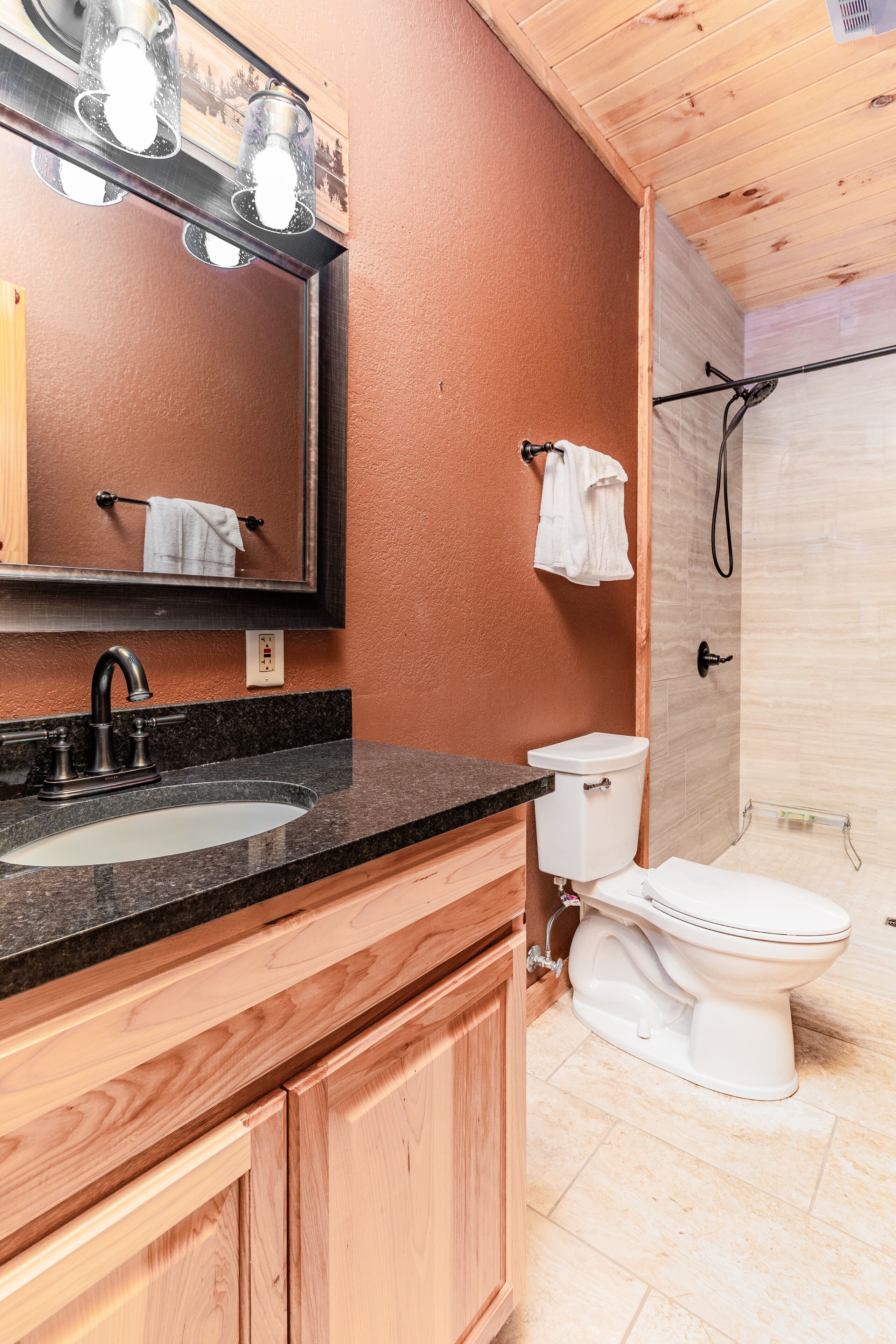 A bathroom with a sink, mirror, and toilet.