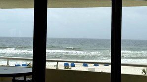 A view of the ocean from a balcony with a railing and blue chairs. - Marisol del Cielo/Sea Sun Of The Sky-On The Beach (Pensacola)