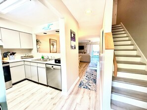 A modern kitchen with white cabinets, a dishwasher, and a sink. - Hidden Gem on Seabrook Island-visit our fabulous beaches on this magical island! (Seabrook Island)