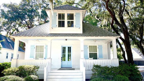 A white house with blue shutters, a front porch, and a number '203' on the door. - Beautiful Cottage on Hilton Head Island, White (Hilton Head Island)