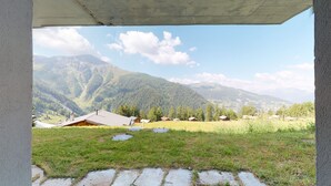 A view of a mountainous landscape with houses and a clear sky.