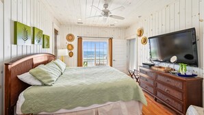 A bedroom with a bed, a television, and a view of the ocean. - Casablanca - Luxury Oceanfront Home in Cherry Grove with Game Room & Pool (North Myrtle Beach)