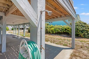 A covered outdoor area with a hose and a water spigot. - Cassie - Pet Friendly, Oceanfront home in Cherry Grove (North Myrtle Beach)