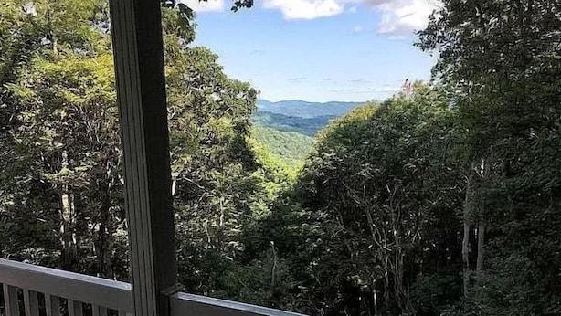 A view from a balcony with dense forest and distant mountains. - Eagle Landing, Views, WI-FI, Private, Spacious! (Boone)