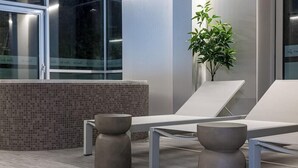 A modern waiting area with two lounge chairs, a small table, and a potted plant. - Grand Baltic Dunes (Palanga)