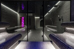 A modern, dimly lit hallway with a starry ceiling, leading to a room with a purple-lit wall. - Grand Baltic Dunes (Palanga)
