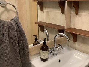 Combined shower/bathtub, hair dryer, towels, toilet paper