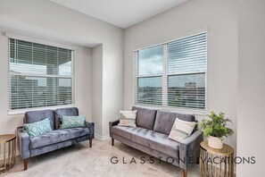 Relax in this stylish living room with two sofas and a view of the urban skyline.