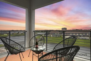 Enjoy breathtaking views of the city skyline and water from this balcony.